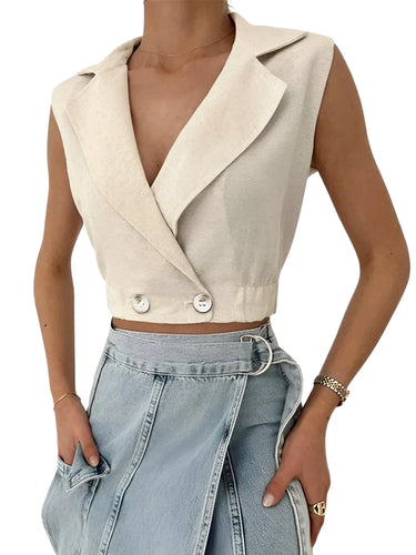 Khaki sleeveless blazer worn with light blue jeans on a white background